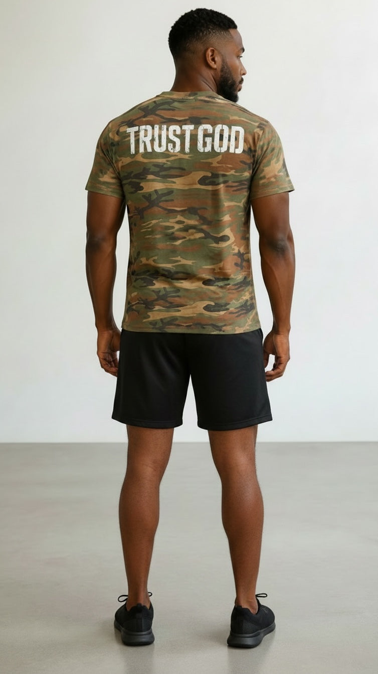 Forged By God camo crewneck t-shirt with Trust God graphic on back, worn by a man with black shorts.