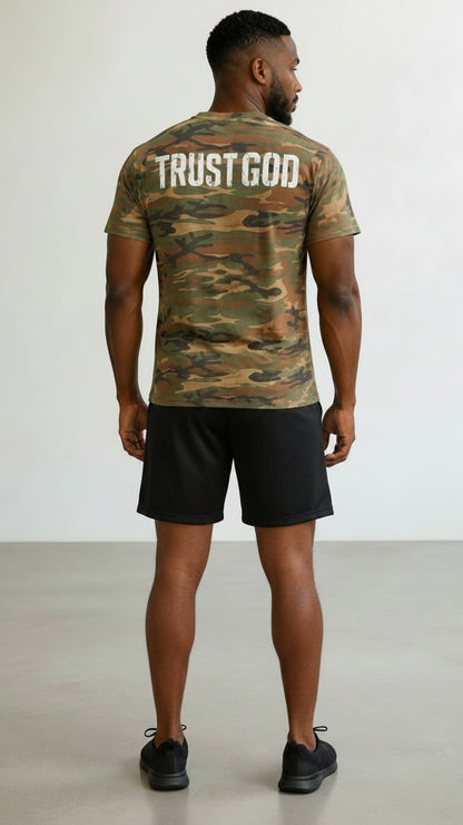 Forged By God camo crewneck t-shirt with Trust God graphic on back, worn by a man with black shorts.