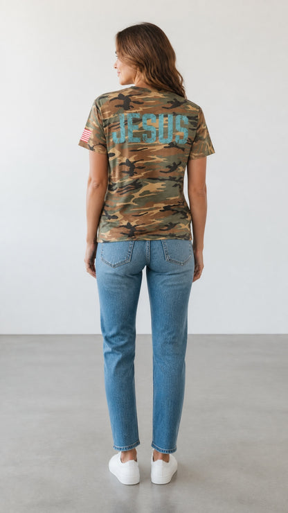 Forged By God camo crewneck t-shirt with distressed JESUS print on back and American flag sleeve detail on a woman.