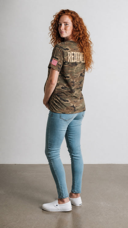 Forged By God camo Redeemed graphic t-shirt with American flag sleeve detail worn by a woman with red hair