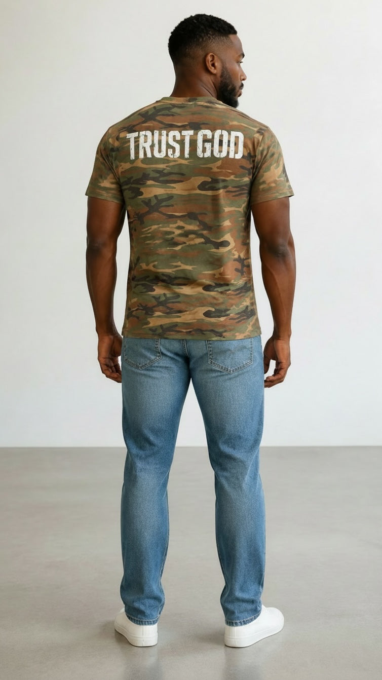 Forged By God camo crew neck t-shirt with distressed white Trust God graphic on back worn by a man with blue jeans