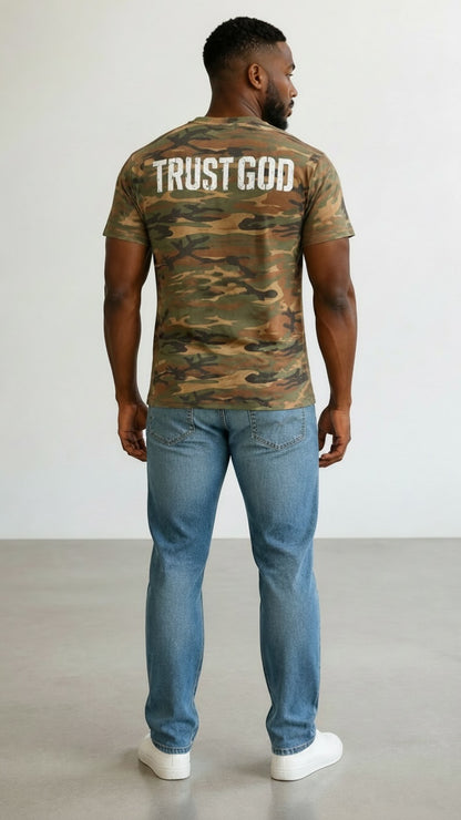 Forged By God camo crew neck t-shirt with distressed white Trust God graphic on back worn by a man with blue jeans