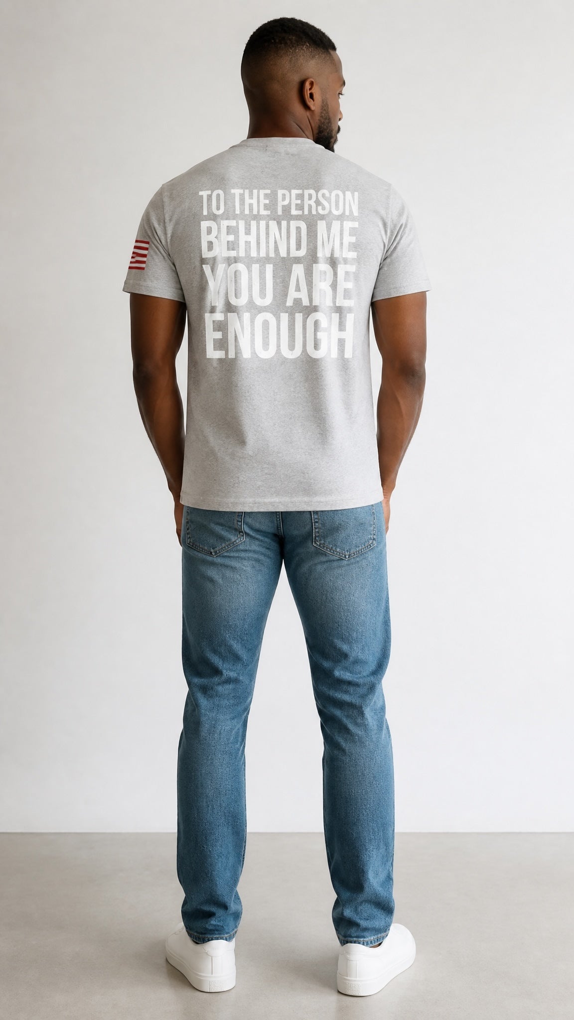 Forged By God grey crewneck t-shirt with white inspirational back print and sleeve flag detail worn by a man