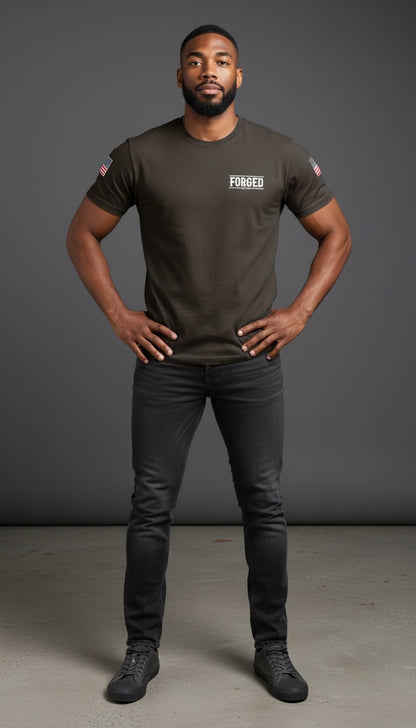 Forged By God olive green crew neck t-shirt with American flag sleeve detail worn by a man in dark jeans